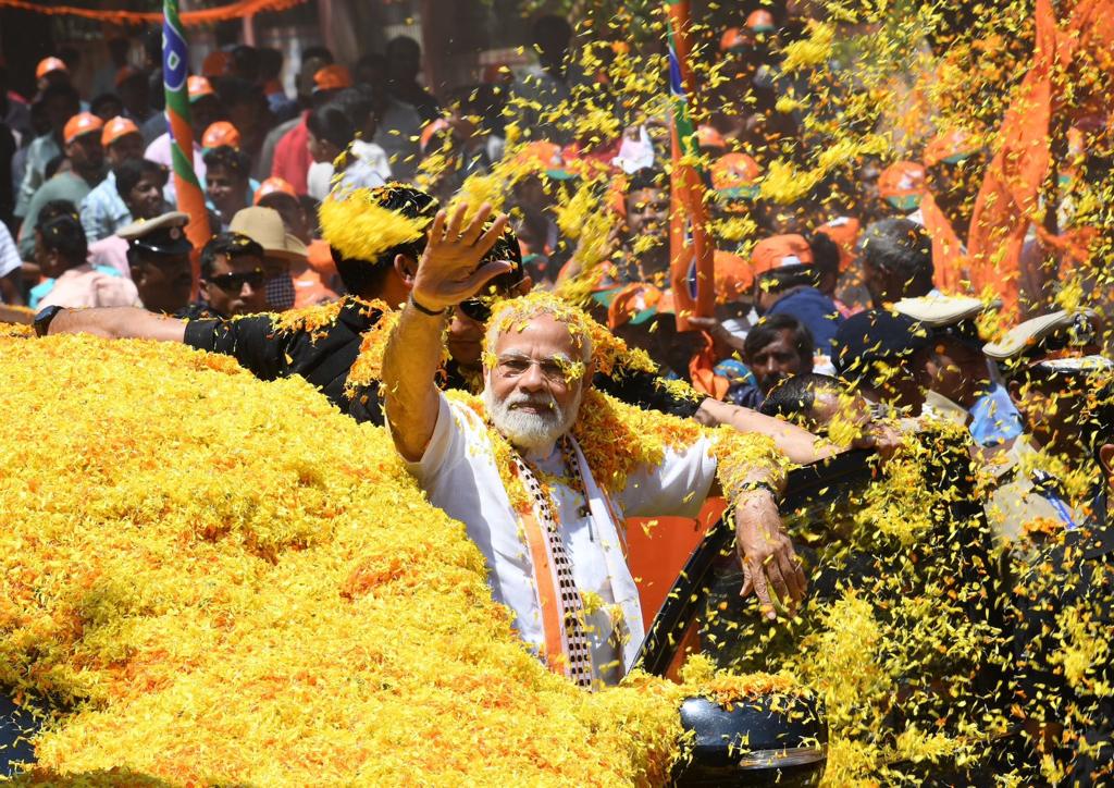 Enthusiastic Modi throws flower petals back at cheering crowd at road-show in poll-bound Karnataka
